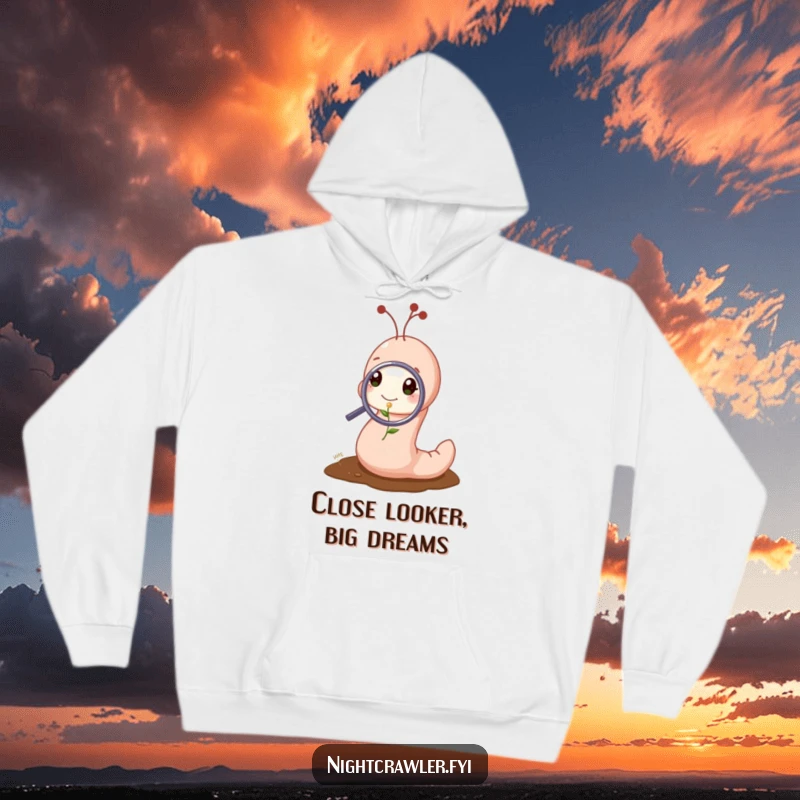 Funny hoodie featuring a cute worm character examining a tiny sprout with a magnifying glass, offering cozy and humorous curiosity.