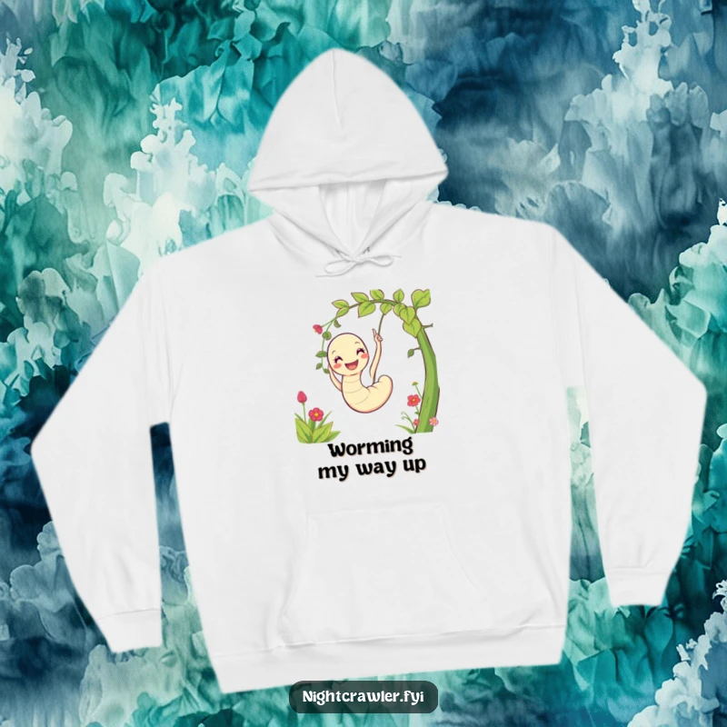 Funny hoodie depicting a contented worm character happily swinging on a vine amidst a vibrant garden, expressing pure delight.