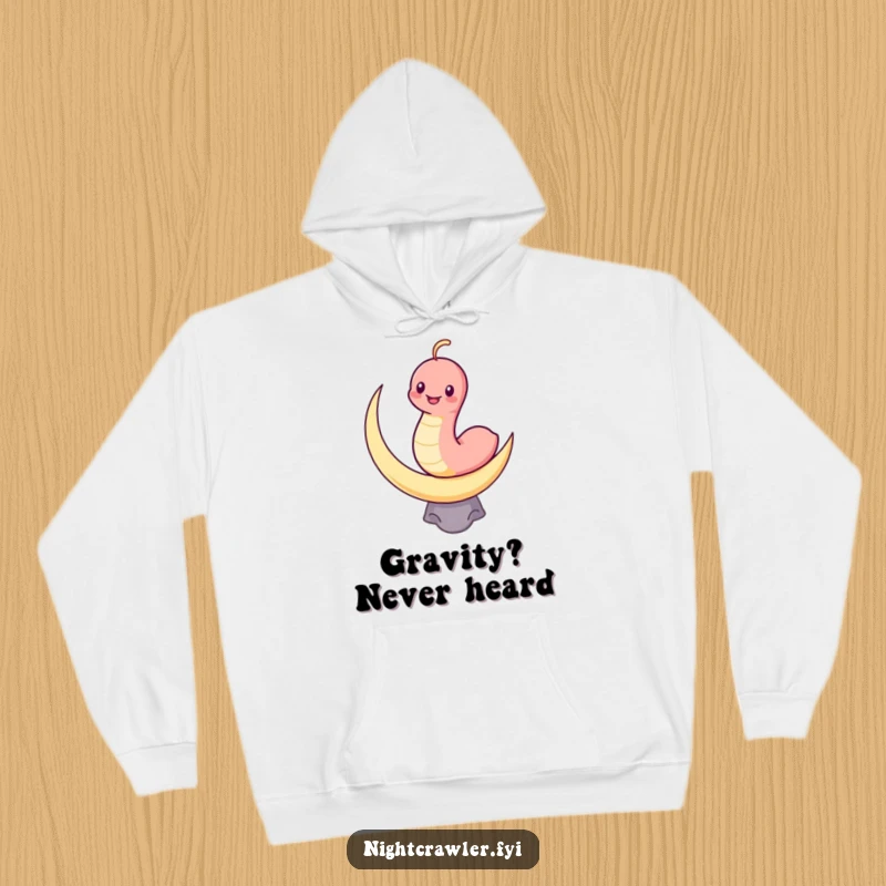 Funny hoodie with a grinning kawaii worm character balancing on a crescent moon, offering cozy and humorous celestial comfort.