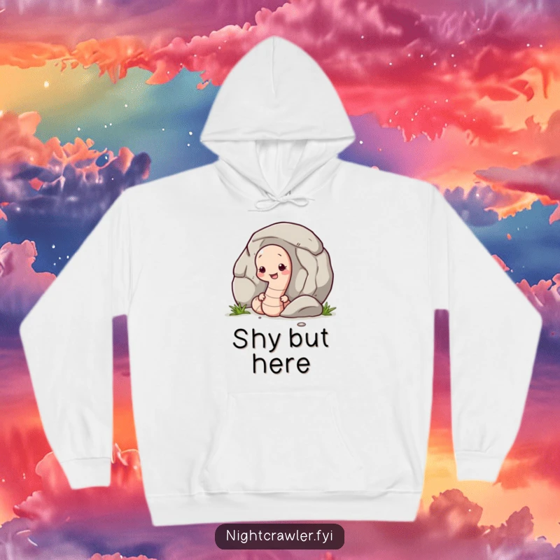 Funny hoodie depicting a shy earthworm character subtly peeking from behind a large pebble, offering comfort and a touch of humor.