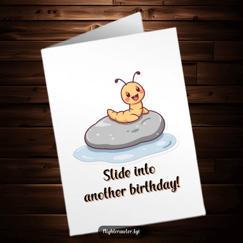 Funny Free Printable Happy Birthday Card showing a joyful worm character sliding down a smooth, wet pebble.