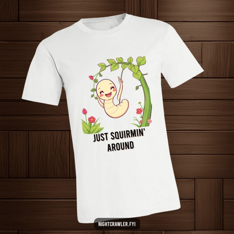 Funny t-shirt with a cheerful worm playfully swinging from a vine in a lush garden, embodying joy and a love for nature.
