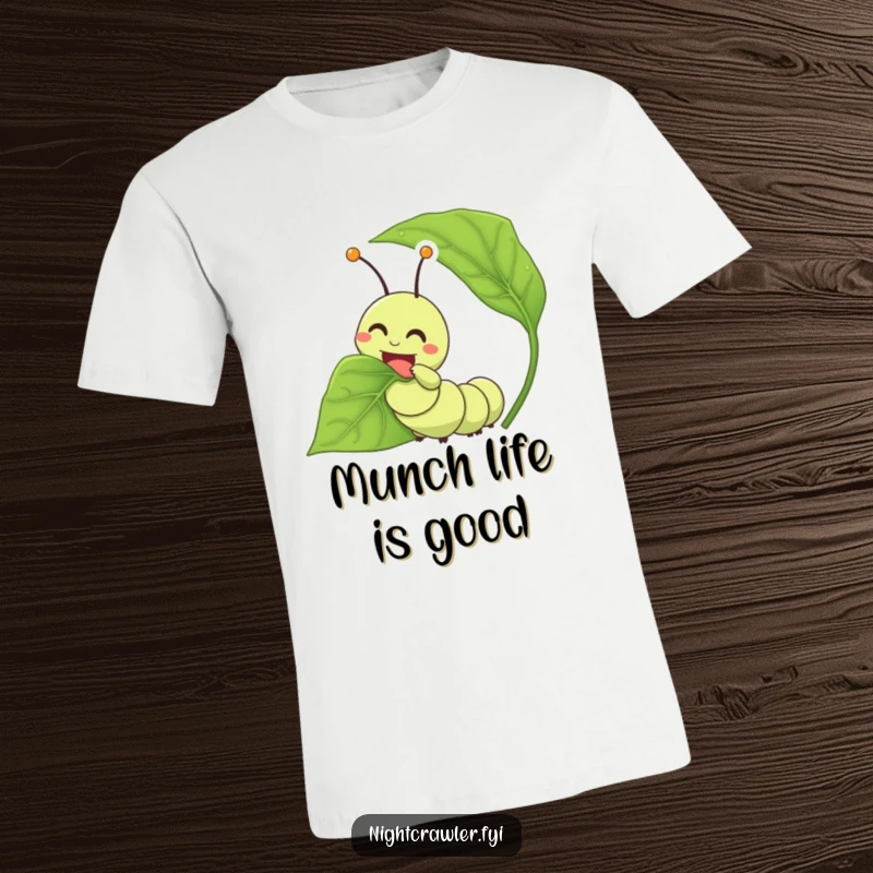 Funny caterpillar t-shirt depicting a joyful character happily munching on an oversized leaf, celebrating deliciousness.