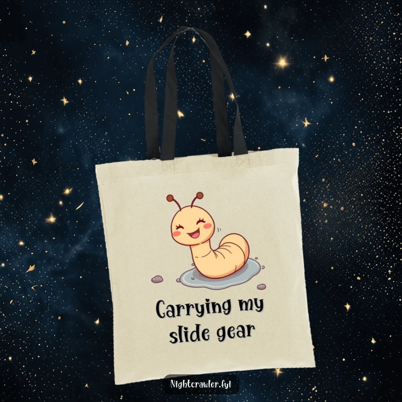 Funny tote bag displaying a joyful worm character sliding down a wet pebble with a wide, happy grin, perfect for carrying laughs.